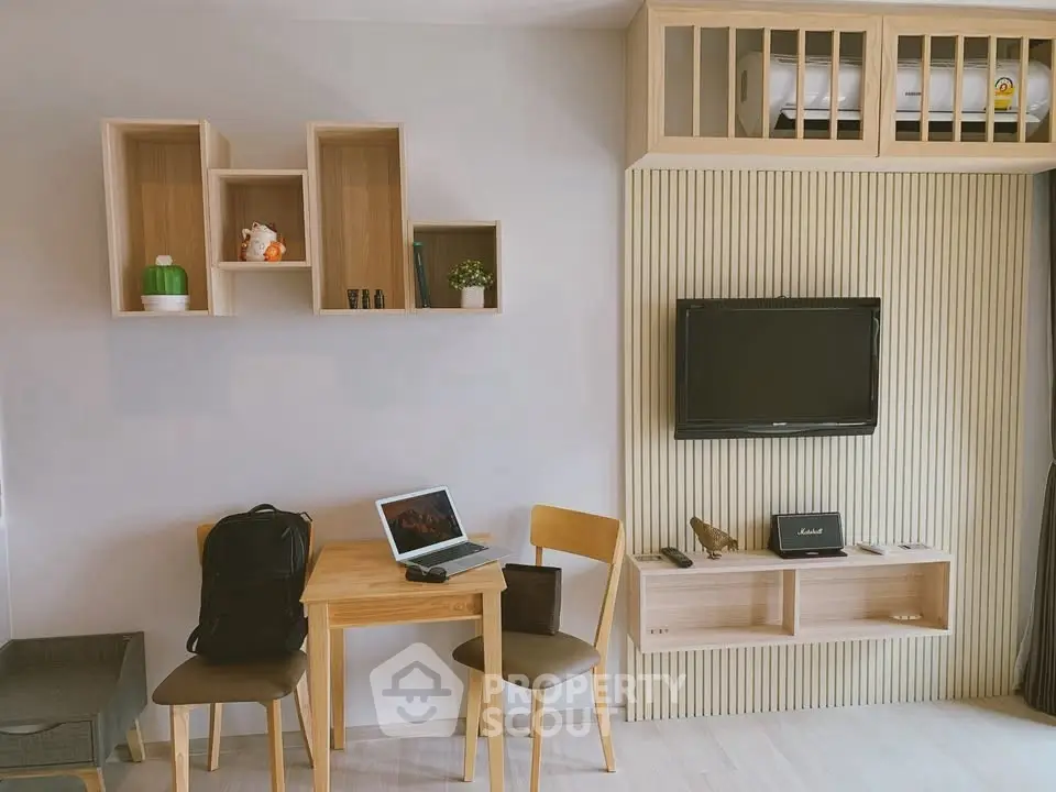 Modern living room with stylish wooden furniture and wall-mounted TV, perfect for cozy urban living.