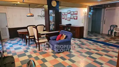 Charming vintage living room with colorful checkered flooring and cozy seating area.