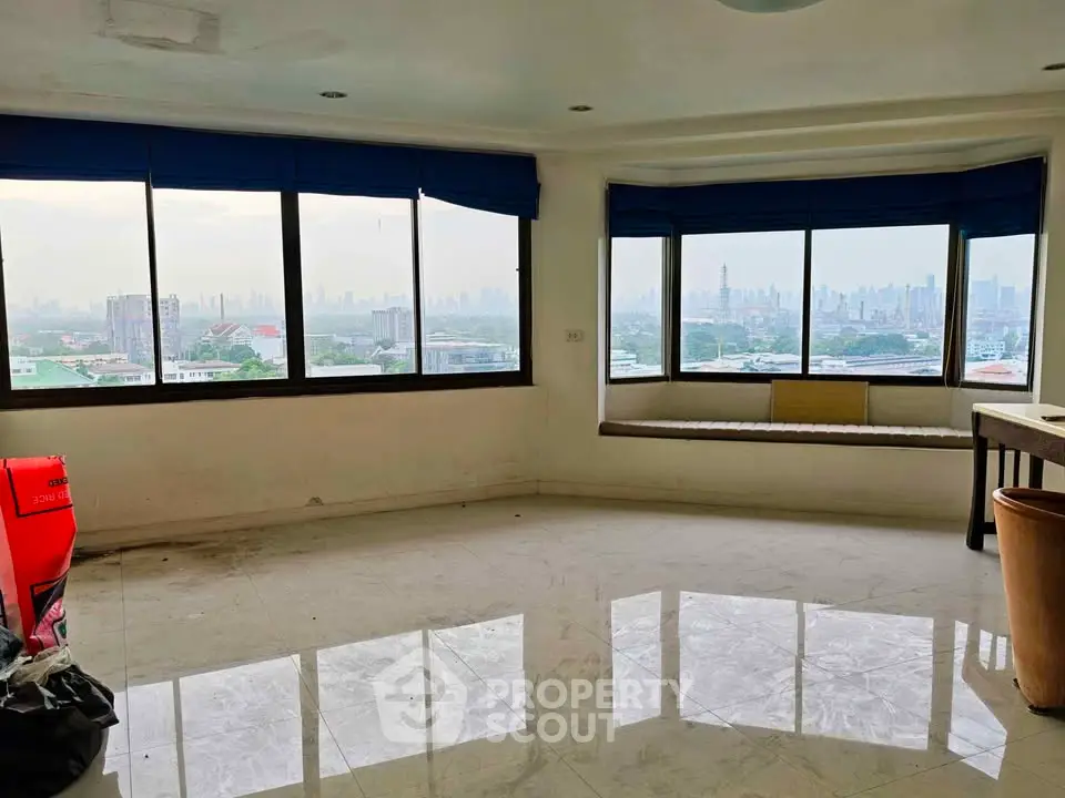 Spacious living room with panoramic city view and large windows