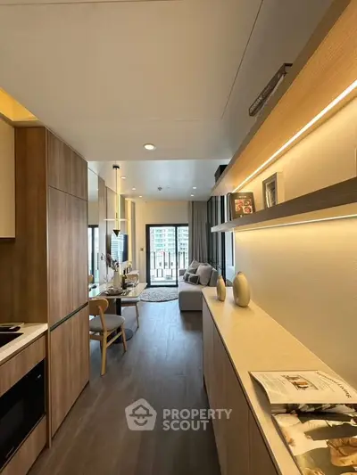 Modern living room with open layout and stylish decor, featuring a cozy seating area and sleek wooden finishes.