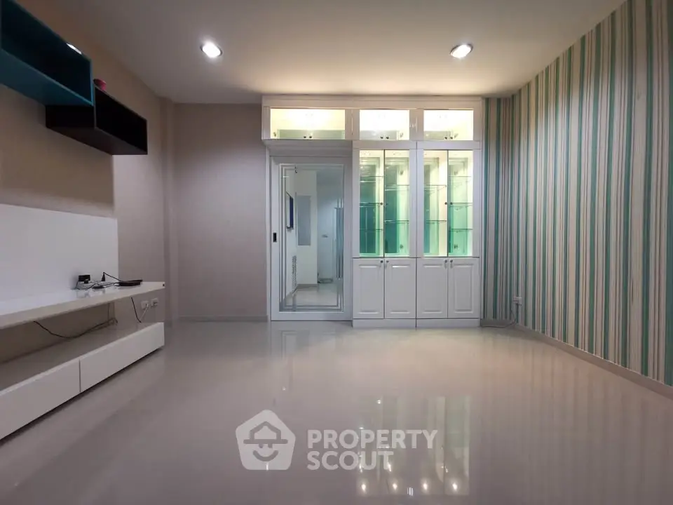 Spacious modern living room with glossy floors and stylish wall accents