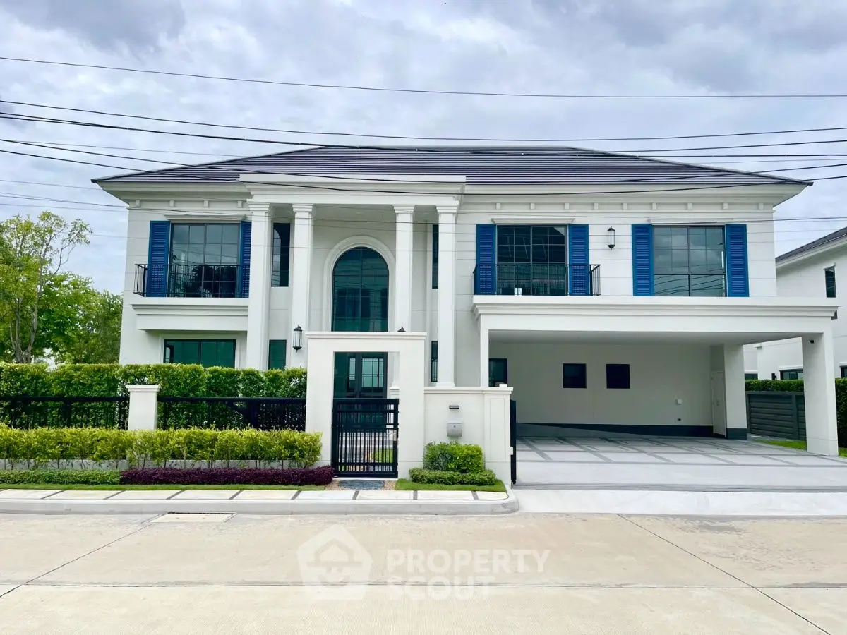Luxurious modern mansion with spacious driveway and elegant facade in upscale neighborhood.