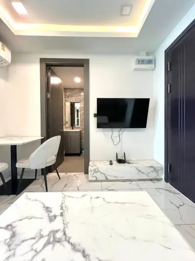 Modern living room with marble accents and wall-mounted TV
