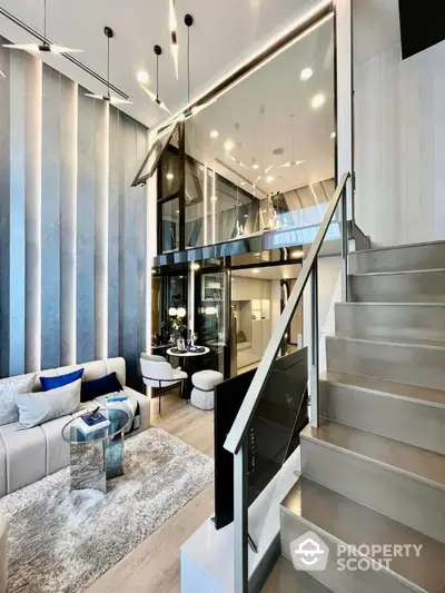 Luxurious multi-level living space with modern staircase, high ceiling, and elegant interior design, perfect for upscale urban living.