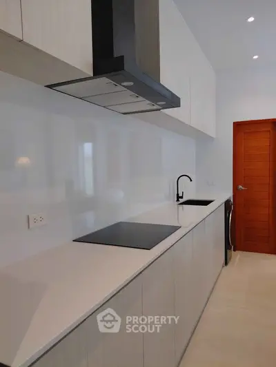 Modern kitchen with sleek cabinetry and induction cooktop