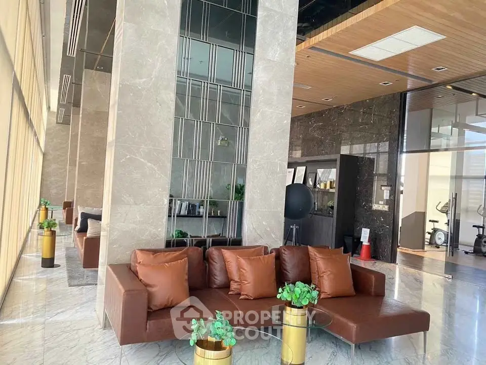 Luxurious modern lobby with elegant seating and marble accents in a high-end building.
