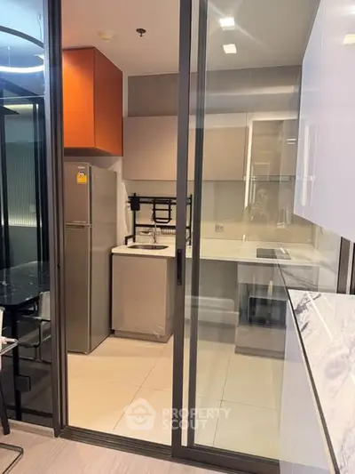Modern kitchen with sleek design, featuring a closed layout and contemporary appliances.