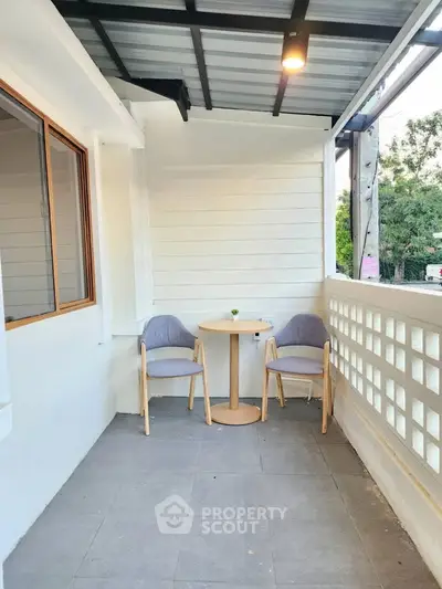 Charming balcony with cozy seating, perfect for relaxation and enjoying the view.
