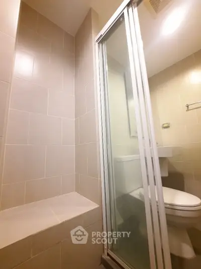 Modern bathroom with glass shower and sleek tile design