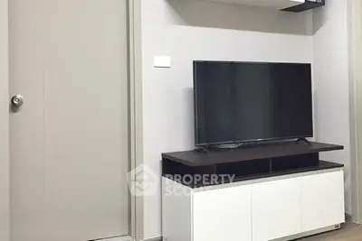 Modern living room with sleek TV stand and flat-screen television
