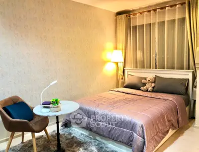 Cozy bedroom with elegant decor, featuring a plush bed, stylish chair, and ambient lighting for a serene atmosphere.
