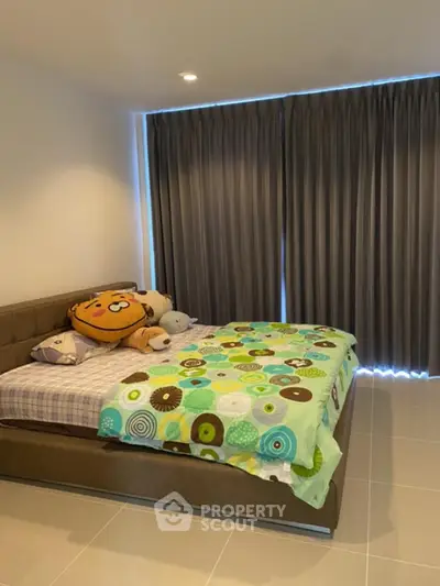 Cozy bedroom with modern decor and large bed, perfect for relaxation.