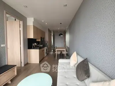 Modern living room with open kitchen layout and stylish decor in a contemporary apartment.