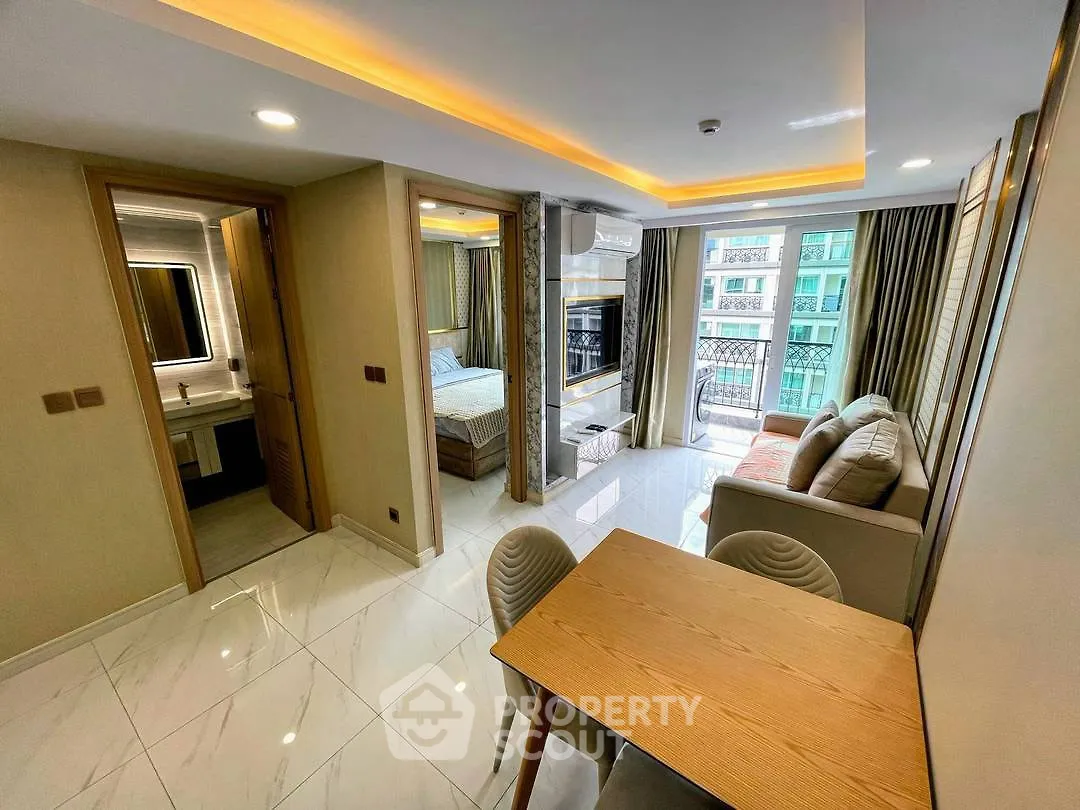 Modern open-plan living room with dining area and bedroom in a stylish apartment