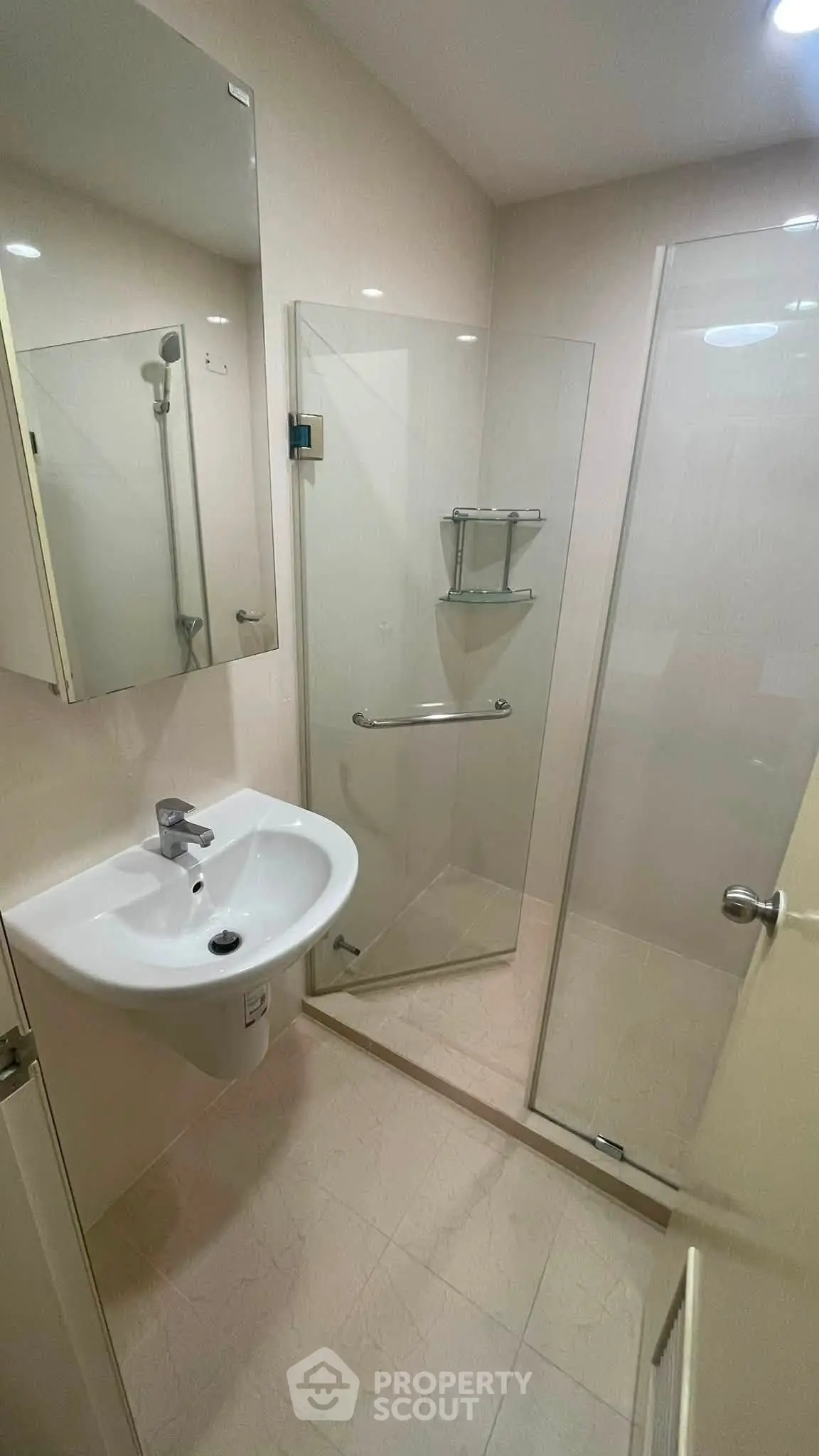 Modern bathroom with glass shower enclosure and sleek fixtures
