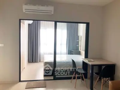 Modern studio apartment with glass partition and minimalist decor