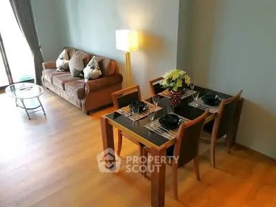 Stylish living room with elegant dining area and cozy sofa, perfect for modern living.