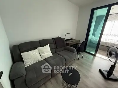 Modern living room with cozy sofa and study area in stylish apartment