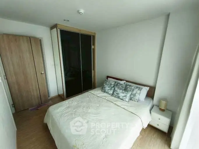 Cozy bedroom with modern wardrobe and stylish decor in a bright apartment.