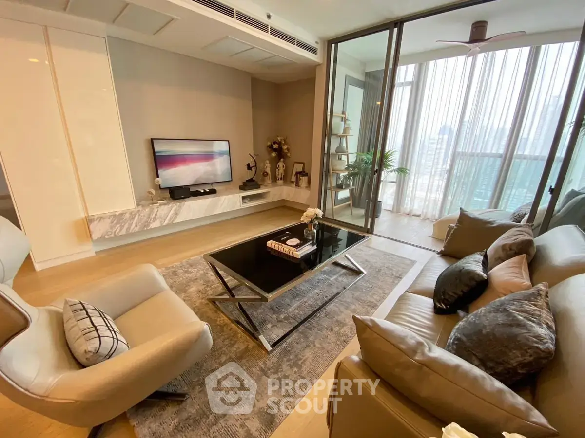 Luxurious living room with modern decor and spacious balcony view.