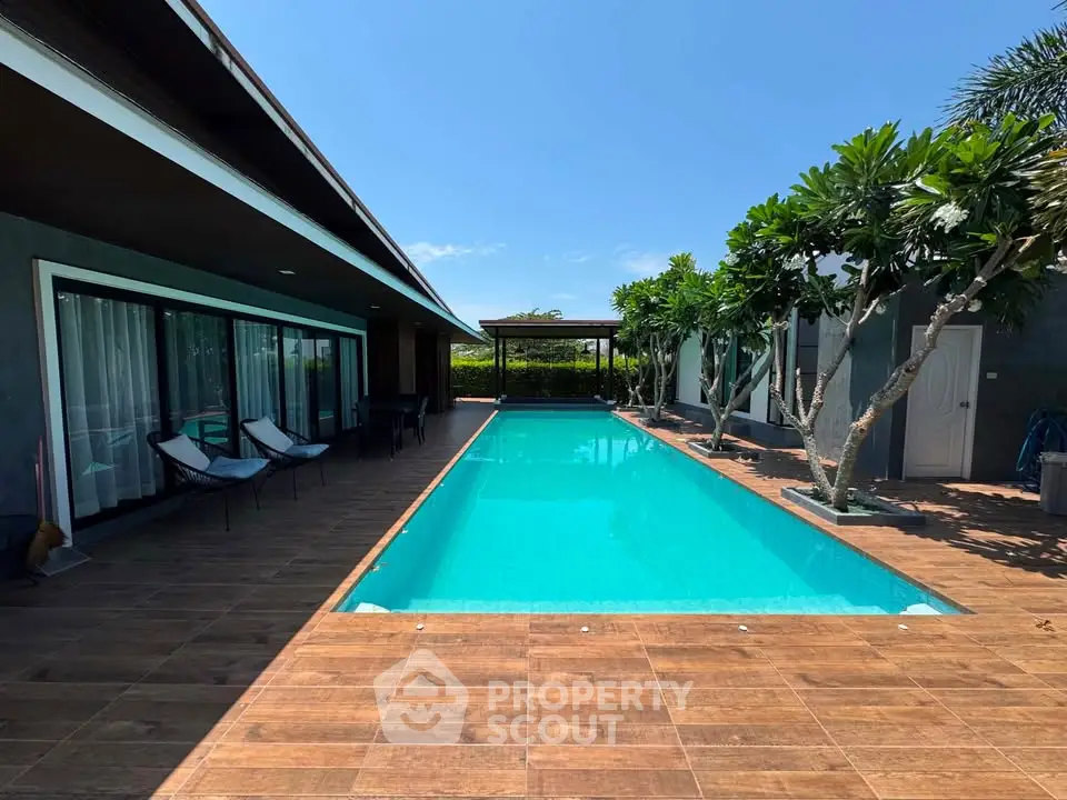 Luxurious villa with private pool and lush greenery, perfect for relaxation and entertainment.