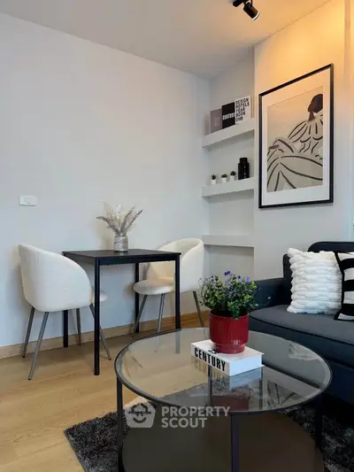 Modern living room with stylish decor, featuring a cozy seating area and elegant dining nook.