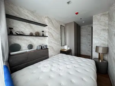 Luxurious modern bedroom with elegant decor and plush bedding in a high-end apartment.