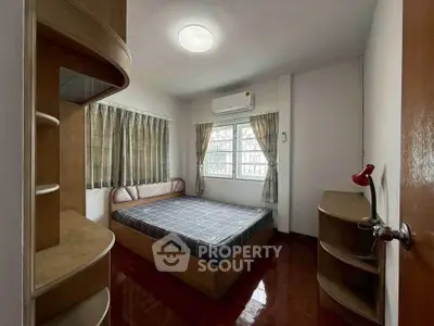 Cozy bedroom with wooden furniture and ample natural light