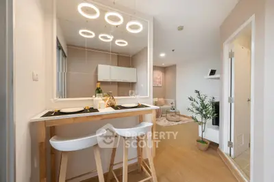 Modern open-plan living area with stylish bar seating and elegant lighting.