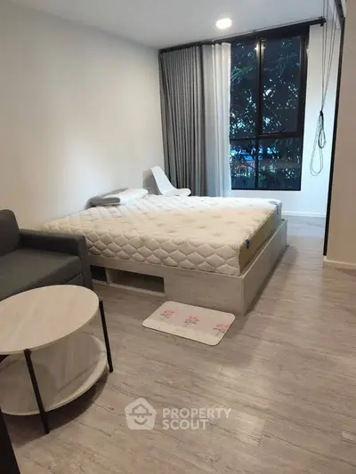 Modern bedroom with stylish decor and large window view