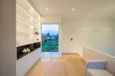 Modern minimalist living room with built-in shelves and scenic view.