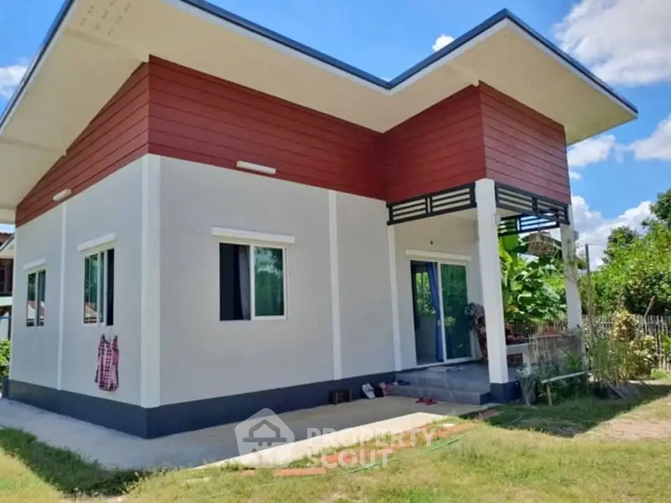 Modern single-story house with unique roof design and spacious yard