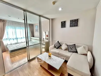 Modern apartment with glass partition, cozy living room, and bright bedroom