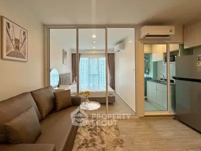 Modern apartment interior with cozy living room and sleek kitchen, featuring stylish decor and ample natural light.