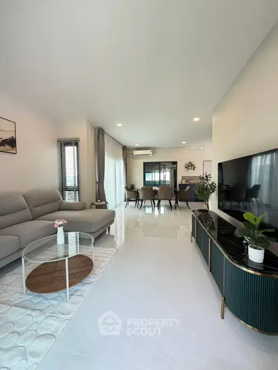 Spacious modern living room with elegant decor and large TV