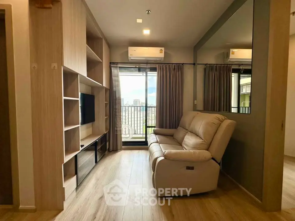 Modern living room with sleek design, featuring a comfortable sofa and a view of the city skyline.