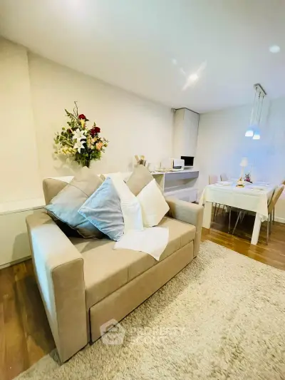 Cozy living room with elegant dining area and plush sofa in modern apartment.