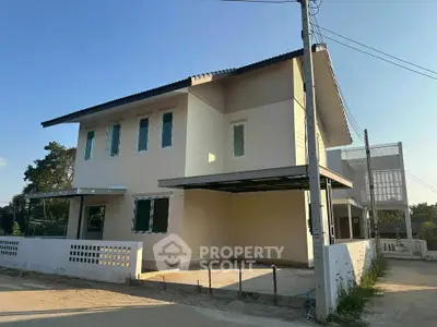 Modern two-story house with spacious driveway and contemporary design in a serene neighborhood.