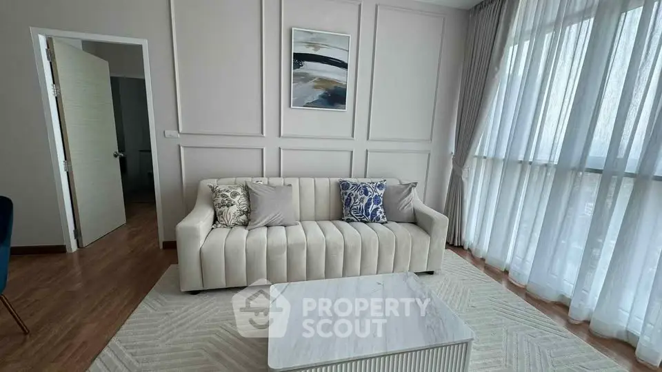 Elegant living room with modern sofa and large windows for natural light