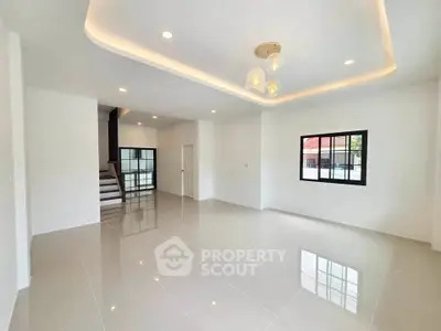 Spacious modern living room with glossy tiled floors and elegant lighting
