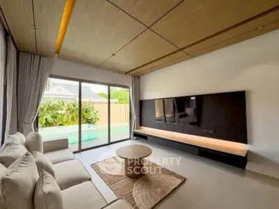 Modern living room with pool view, featuring sleek furniture and natural lighting.
