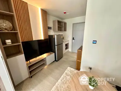 Modern apartment interior with stylish furniture and appliances, featuring a cozy living area and sleek kitchen.