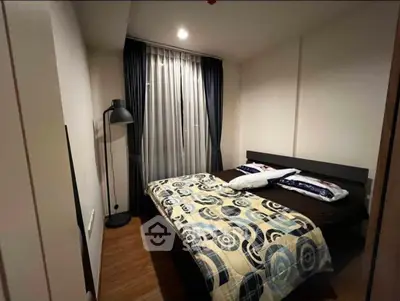 Cozy bedroom with modern decor and stylish lighting in a contemporary apartment.