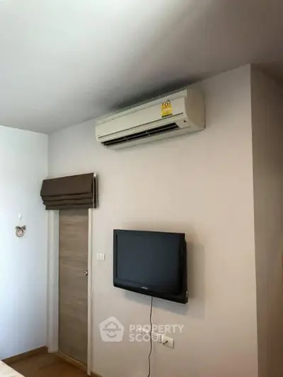 Modern bedroom with air conditioning and wall-mounted TV for comfort and entertainment.