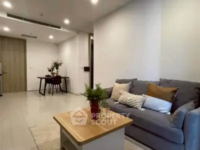 Modern living room with cozy sofa and stylish dining area