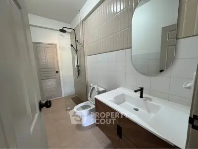 Modern bathroom with sleek fixtures and glass shower enclosure