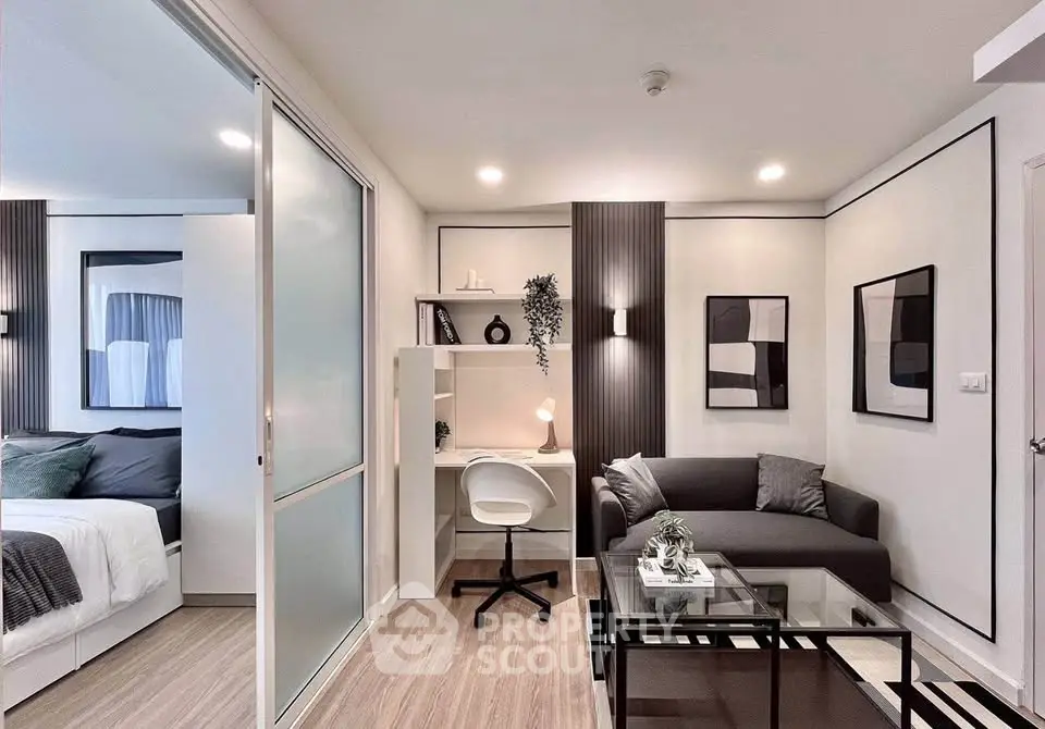 Modern living room with study area and stylish decor in a contemporary apartment.