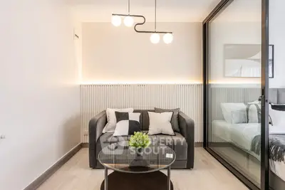 Modern living room with stylish sofa and glass partition