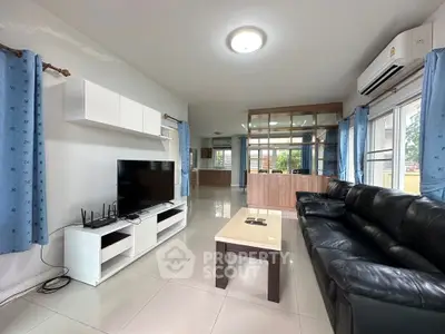 Spacious living room with modern furnishings and large windows for natural light.