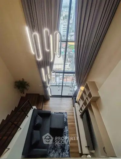 Stunning loft apartment with floor-to-ceiling windows and modern lighting in a vibrant city view setting.